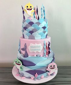 a three tiered cake decorated with sea creatures