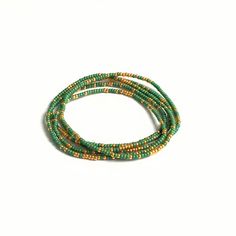 Beautiful delicate wrap bracelet, wraps around your wrist 5 times. Lovely color combination of green with a hint of golden seed beads which gives the bracelet a lovely sparkle. M A T E R I A L * Delica Seed beads from Miyuki ( 2 mm) green & gold * Very strong elastic S I Z E Size medium, 86 cm ( 34 inch), 6.7 inch when wrapped, fits the normal to small wrist. Can be made in any size ( please sent me a message with your order and it will be made for you) S H I P P I N G * All orders are wrapp Western Bracelets, Peridot Bracelet, Boho Wrap Bracelet, Essential Oil Diffuser Bracelet, Black Beaded Bracelets, Turquoise Bead Bracelet, Diffuser Jewelry, Seed Bead Bracelet, Simple Bracelets