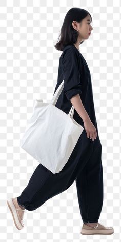 a woman walking with a white bag on her back