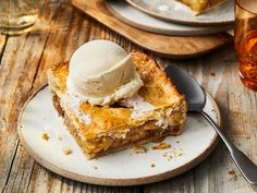 a piece of pie with ice cream on top is sitting on a plate next to a fork