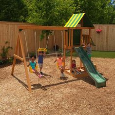 three children playing on a wooden swing set