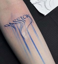 a person with a tattoo on their arm that has blue lines coming out of it