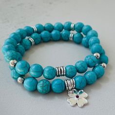 Elevate your style with our Natural Turquoise Gemstone Bracelet set (you will get 2 bracelets of same size) featuring a charming Clover Leaf charm in one of them. Handcrafted with precision and infused with positive energy, this bracelet is a stunning blend of turquoise beauty and symbolic luck. The vibrant turquoise beads, each carefully selected for their unique colour variations, bring a sense of tranquillity and balance to the design. Known for its protective and healing properties, turquois Turquoise Beaded Bracelets With Charms As Gift, Hypoallergenic Turquoise Round Beads Bracelets, Meditation Bracelet, Turquoise Bead Bracelet, Clover Charm, Stackable Bracelets, Leaf Charms, Genuine Turquoise, Turquoise Gemstone