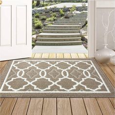 a door mat with an entrance way and steps in the background