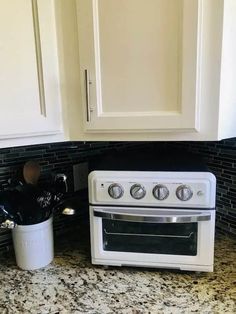 a white stove top oven sitting inside of a kitchen