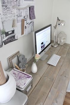 a computer monitor sitting on top of a wooden desk