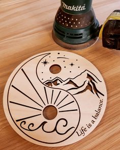 a wooden disk with the words life is a journey written on it next to a grinder