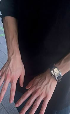 a close up of a person wearing a watch on their wrist