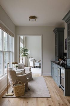 a living room filled with furniture and lots of windows