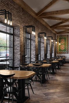 an empty restaurant with wooden tables and chairs