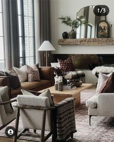 a living room filled with furniture and a fire place next to a large mirror on the wall