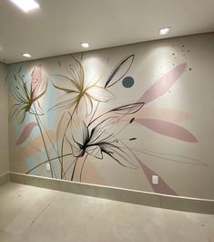 an empty room with painted flowers on the wall