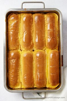 a metal pan filled with bread on top of a table