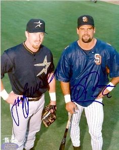 two baseball players standing next to each other on a field