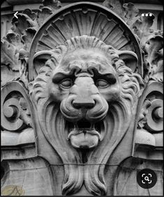 a lion's head is shown on the side of a building in black and white