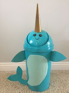 a blue trash can with a gold horn on it's head and a sea creature inside