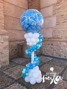 blue and white balloons in the shape of an eiffel tower with swirls