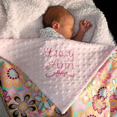 a baby wrapped up in a blanket with the words lacy ann on it