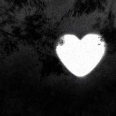 a white heart shaped object in the dark