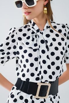 Subcategory: Blouse. Collar: High collar neckline. Sleeves: Short Sleeves. Print: Polka-dot print. Fit: Standard fit. Style: Daily. Fabric: Lightweight woven fabric . Product details: Knot detail. runs true to size. S. 100% Polyester Chic Polka Dot Blouse For Workwear, Chic Spring Tops With Bow Print, Elegant Polka Dot Blouse For Work, Trendy Tie Neck Blouse For Office, Fitted Blouse With Tie Sleeves And Tie Neck, Fitted Tie Neck Blouse With Tie Sleeves, White Tie Neck Blouse For Office, Black Tie Neck Blouse For Summer, Trendy Spring Blouse With Bow