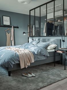 a bedroom with a bed, mirror and shoes on the floor