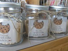 three jars filled with cookies on top of a counter