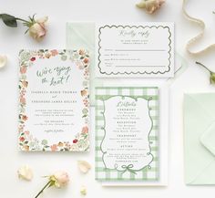 the wedding stationery is laid out with flowers