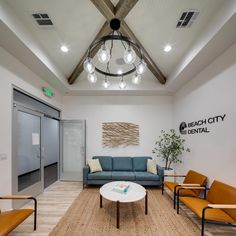 a living room filled with furniture and a chandelier