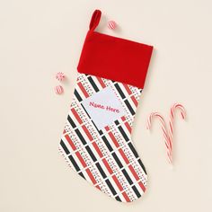 a christmas stocking and candy canes on a white surface with a name here tag