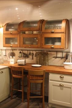 a kitchen with wooden cabinets and white walls