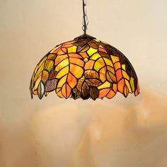 a stained glass lamp hanging from a ceiling