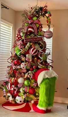 a christmas tree decorated with red, green and white ornaments