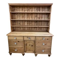 an old wooden dresser with drawers and cupboards