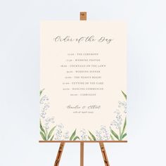 an easel with a wedding program on it and the words order of the day written in cursive writing