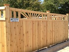 a wooden fence that has a sign on it