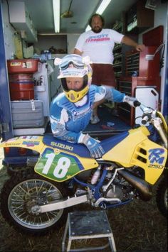 a man sitting on top of a dirt bike