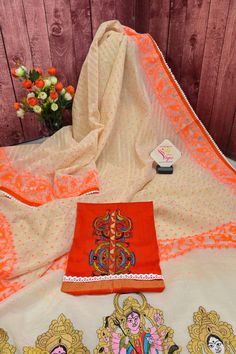 Now get ready with our latest designer jamdani collection with a pallu that comes with a machine-embroidered Durga family with lace work on the border. With all-over self-weaving work, this is a must-buy this puja season. Color: A shade of offwhite and orange color Technique: Comes with lace border and machine embroidered Durga family on the pallu Fabric: Cotton NOTE: Comes with a kalka (paisley) embroidered blouse piece Off White Semi-stitched Cutdana Sets, Off White Saree With Cutdana, Off White Embroidered Blouse With Traditional Drape, Embroidered Off White Blouse With Traditional Drape, Embroidered Off White Georgette Sets, Embroidered Off-white Blouse Piece With Traditional Drape, Off White Embroidered Georgette Sets, Traditional Designer Wear Off White Blouse Piece, Bollywood Chanderi Off White Set