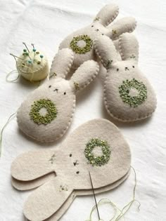 four white bunny ornaments are sitting on a table