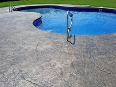 an empty swimming pool in the middle of a yard