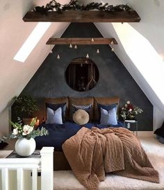 a bedroom with a large bed and mirror above it