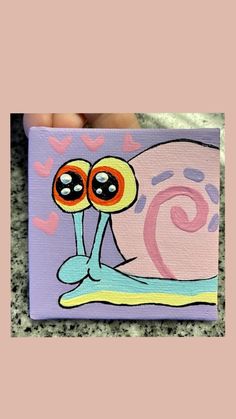 a painting of a snail with two eyes on it's face and hearts in the background