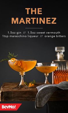 the martini is served in coupe glasses with an orange garnish