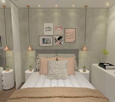 a bed sitting in a bedroom next to two lamps and pictures on the wall above it