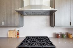 a stove top oven sitting inside of a kitchen