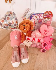 a teddy bear sitting in a basket next to some shoes and other items on the floor