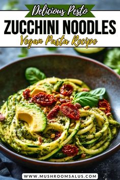 zucchini noodles with pesto sauce in a bowl on top of a table