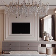 an elegant living room with chandelier and large television mounted on the wall above it