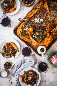 an overhead view of some food on a table with wine glasses and sauces next to it