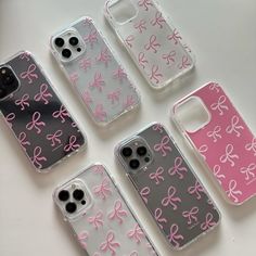 four cell phones with bows on them are sitting next to each other in different colors