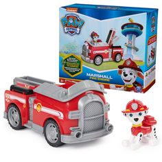 a toy fire truck with a dog figurine next to it's box